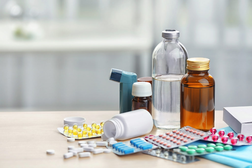 Different medicines and pills on pharmacy table